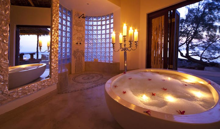 A luxurious bathroom with oversized bath at Quilalea Private Lodge, Mozambique