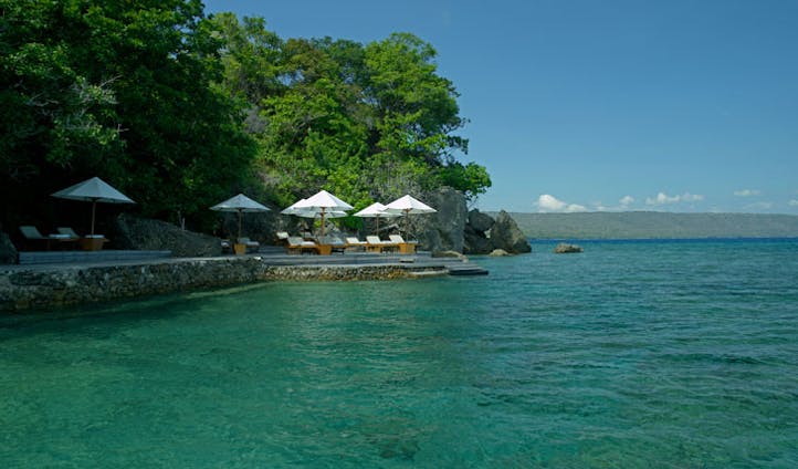 Luxury hotel boardwalk and sea at Amanwana on Mojo Island, Indonesia