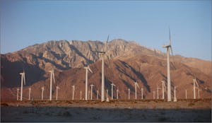Sustainable energy, wind farm in front of mountains
