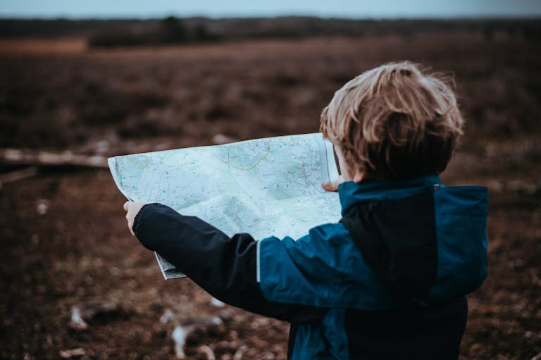 child holding a map, luxury family holidays