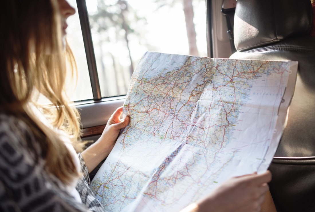 teenager with map for family road trip