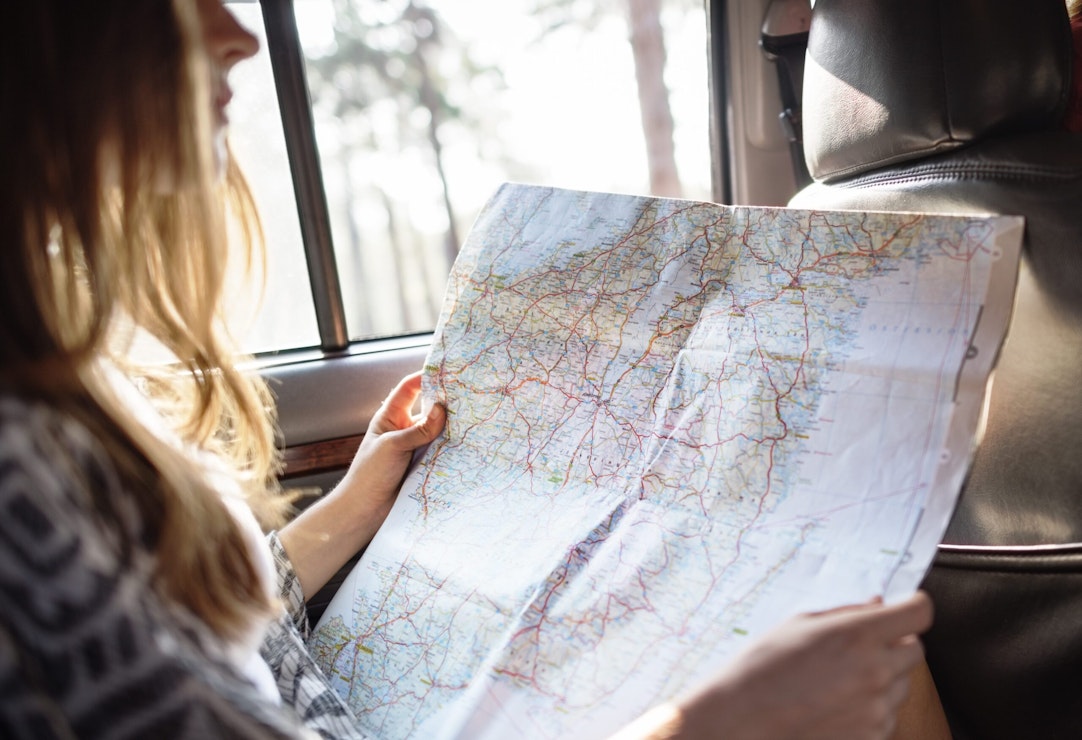 teenager with map for family road trip