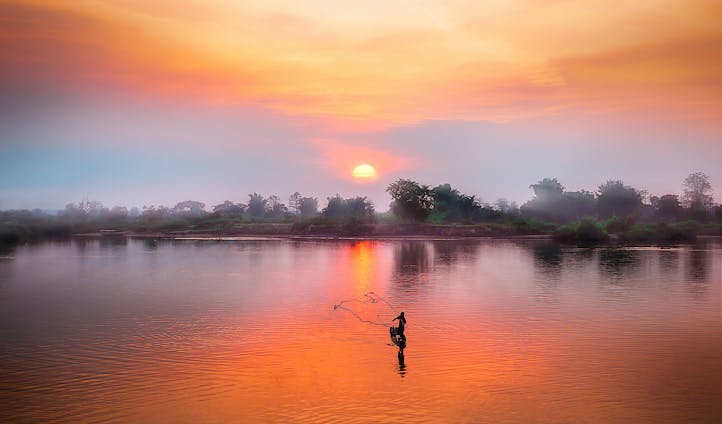 Laos person fishsing, Luxury vacations Cambodia and Laos