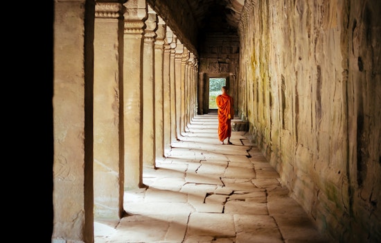 Monk wandering through temple in Cambodia