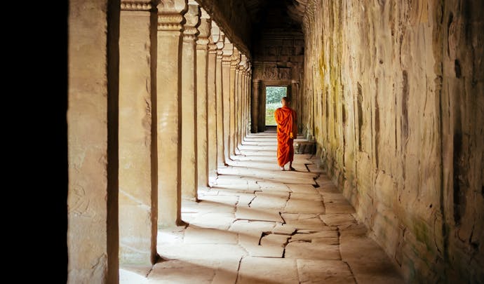 Monk wandering through temple in Cambodia