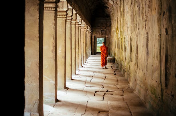 Monk wandering through temple in Cambodia