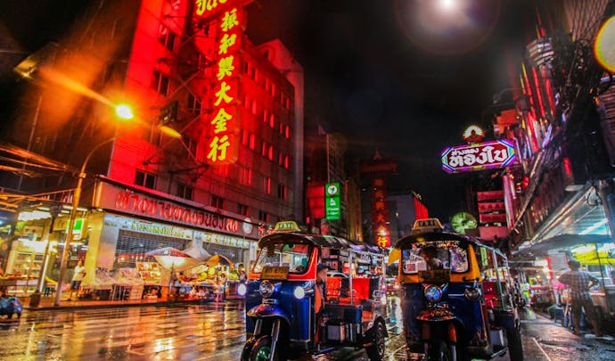 Bangkok at night with tuk tuks and bright lights, Thailand