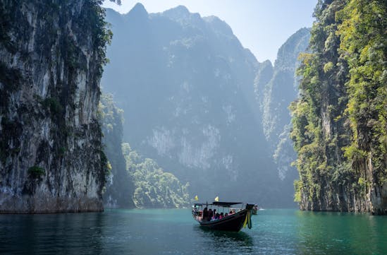 A boat travels through rocky outcrops in Thailand