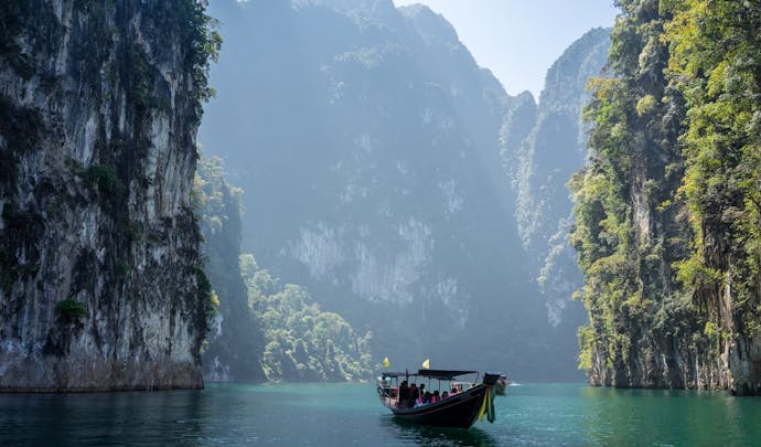 A boat travels through rocky outcrops in Thailand
